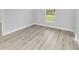 Cozy bedroom with wood-look floors and a bright window at 13345 Sw 106 St, Dunnellon, FL 34432