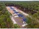 Aerial view of multiple homes in a community with a backdrop of large trees at 14790 Sw 32 Pl, Ocala, FL 34481