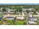 An aerial view of a neighborhood featuring well-maintained homes, green lawns, and mature trees at 1520 Ne 17Th Ave, Ocala, FL 34470