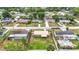 An aerial view of a neighborhood featuring well-maintained homes, green lawns, and mature trees at 1520 Ne 17Th Ave, Ocala, FL 34470