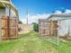A fenced-in backyard featuring multiple gates, a gravel path, and well-maintained grass at 1520 Ne 17Th Ave, Ocala, FL 34470