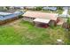 Wide angle shot of a backyard with a covered patio and lawn, perfect for outdoor enjoyment at 1520 Ne 17Th Ave, Ocala, FL 34470