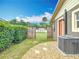 A landscaped backyard featuring an air conditioner, pebble ground cover, and privacy fencing at 1520 Ne 17Th Ave, Ocala, FL 34470