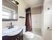 Well-lit bathroom features a modern vanity, sink, toilet, and shower with curtain at 1520 Ne 17Th Ave, Ocala, FL 34470