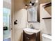 Cozy half bath with dark vanity, a framed mirror and open shelving, convenient for guests at 1520 Ne 17Th Ave, Ocala, FL 34470
