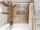 Stylish bathroom with tub, custom tile work, bronze fixtures and decorative shelves at 1520 Ne 17Th Ave, Ocala, FL 34470