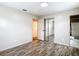 Inviting bedroom with wood-look flooring, a mirrored closet and a bathroom entrance at 1520 Ne 17Th Ave, Ocala, FL 34470