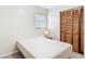 Bright bedroom featuring closet, window with blinds, a bed and a bedside table at 1520 Ne 17Th Ave, Ocala, FL 34470