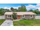 Charming home has a metal roof, lush lawn, and inviting curb appeal at 1520 Ne 17Th Ave, Ocala, FL 34470