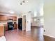 Bright kitchen with black appliances and wooden cabinets, open to the entryway at 1520 Ne 17Th Ave, Ocala, FL 34470