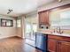 This kitchen features vinyl floors, wood cabinets and a sliding glass door to the outside at 1520 Ne 17Th Ave, Ocala, FL 34470