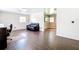 Open living room with dark wood floors, natural light, and a view into the eat-in kitchen at 1520 Ne 17Th Ave, Ocala, FL 34470