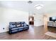 Cozy living room boasts wood floors, access to the kitchen, and comfortable seating at 1520 Ne 17Th Ave, Ocala, FL 34470