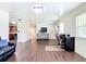 Open-plan living room with wood flooring, adjacent kitchen, and comfortable seating at 1520 Ne 17Th Ave, Ocala, FL 34470