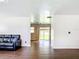 Bright living room with dark wood floors and a leather sofa, leading to a sliding glass door at 1520 Ne 17Th Ave, Ocala, FL 34470