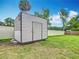 Backyard view of storage shed, with metal siding and a concrete foundation, set in a fenced yard at 1520 Ne 17Th Ave, Ocala, FL 34470