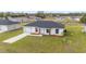 Lovely home featuring a manicured lawn, white garage door, and inviting gray-trimmed front entrance at 15424 Sw 27 Ln, Ocala, FL 34481