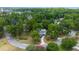 An aerial view showcases a home nestled among lush trees in a quiet neighborhood at 1628 Se 29Th Ter, Ocala, FL 34471