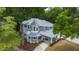 A two-story home with gray siding, a porch, and a porte-cochere are seen from an aerial view at 1628 Se 29Th Ter, Ocala, FL 34471