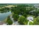 An aerial view showcases this home's setting near a pond, mature trees, and spacious green areas at 1628 Se 29Th Ter, Ocala, FL 34471
