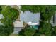 An aerial view of the property shows the house, pool, detached garage, and surrounding greenery at 1628 Se 29Th Ter, Ocala, FL 34471