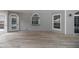 Spacious outdoor back porch with wooden flooring and arched doorways at 1628 Se 29Th Ter, Ocala, FL 34471