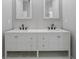 Bathroom featuring double sink vanity, marble backsplash, and modern faucets at 1628 Se 29Th Ter, Ocala, FL 34471