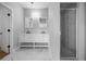 Bathroom with double sink vanity, a shower, white marble floors, and neutral walls at 1628 Se 29Th Ter, Ocala, FL 34471