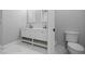 Bright bathroom with marble flooring, modern vanity and dual sinks at 1628 Se 29Th Ter, Ocala, FL 34471