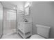 Bathroom featuring a vanity sink with framed mirror, tile shower, and toilet at 1628 Se 29Th Ter, Ocala, FL 34471
