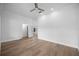 Spacious bedroom features wood-look flooring, neutral walls, a ceiling fan, and an open doorway at 1628 Se 29Th Ter, Ocala, FL 34471