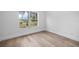 Bright bedroom with a large window view and wood grain flooring at 1628 Se 29Th Ter, Ocala, FL 34471