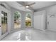 Brightly lit bonus room with tile flooring, large windows, and ceiling fan at 1628 Se 29Th Ter, Ocala, FL 34471