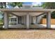 Attached carport with covered entry, gray siding, and concrete driveway at 1628 Se 29Th Ter, Ocala, FL 34471