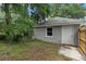 A side view of the gray home reveals a well-maintained exterior with a manicured yard at 1628 Se 29Th Ter, Ocala, FL 34471
