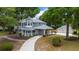 A beautiful two-story home with gray siding, porch, porte-cochere, and three-car garage at 1628 Se 29Th Ter, Ocala, FL 34471