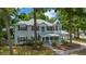 The charming two-story home with gray siding boasts a welcoming front porch, a turret, and lush landscaping at 1628 Se 29Th Ter, Ocala, FL 34471