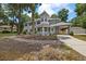 Beautiful two-story home with gray siding, porch, porte-cochere, and well-manicured yard at 1628 Se 29Th Ter, Ocala, FL 34471