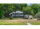 A two-story home with blue siding sits amongst the trees at 1628 Se 29Th Ter, Ocala, FL 34471