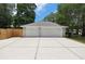 A spacious two-car garage features white doors and a concrete driveway at 1628 Se 29Th Ter, Ocala, FL 34471