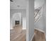 Inviting hallway with wood floors, staircase and an archway leading to the fireplace at 1628 Se 29Th Ter, Ocala, FL 34471