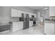 Kitchen featuring white cabinetry and stainless steel appliances on tile floor at 1628 Se 29Th Ter, Ocala, FL 34471