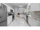 Open concept kitchen with new white cabinets, stainless appliances, and granite countertops at 1628 Se 29Th Ter, Ocala, FL 34471