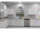 Well-lit kitchen with granite countertops and stainless steel dishwasher and sink at 1628 Se 29Th Ter, Ocala, FL 34471
