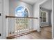 Upstairs landing with a decorative railing and large window view of the community pond at 1628 Se 29Th Ter, Ocala, FL 34471