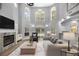 Bright living room with a fireplace, soaring ceilings, and abundant natural light at 1628 Se 29Th Ter, Ocala, FL 34471