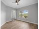 Bright living room with wood floors, large window, and front door at 1628 Se 29Th Ter, Ocala, FL 34471