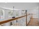 Open loft area overlooking the main living space with hardwood floors and natural light at 1628 Se 29Th Ter, Ocala, FL 34471