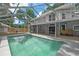 Backyard pool with screened-in enclosure, concrete patio, and access to house at 1628 Se 29Th Ter, Ocala, FL 34471