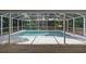 Screened-in pool with concrete patio and wood deck area at 1628 Se 29Th Ter, Ocala, FL 34471